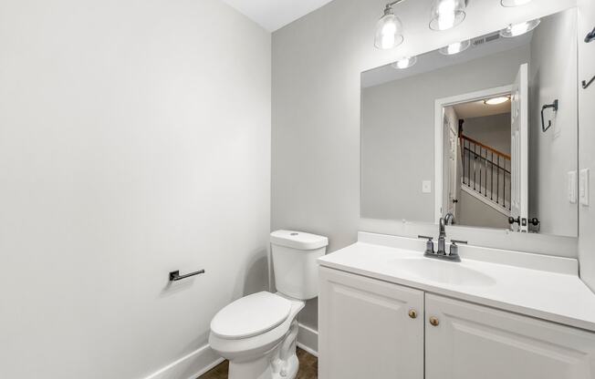 Bathroom/ powder room with a sink toilet and a mirror at Crogman School Lofts, Atlanta, 30315