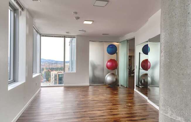 A room with a view of the mountains through the window.