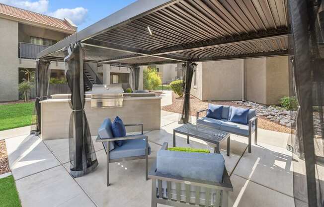 Outdoor BBQ Area with Furniture and Canopy at Saddle Ridge Apartments in Tucson, AZ.
