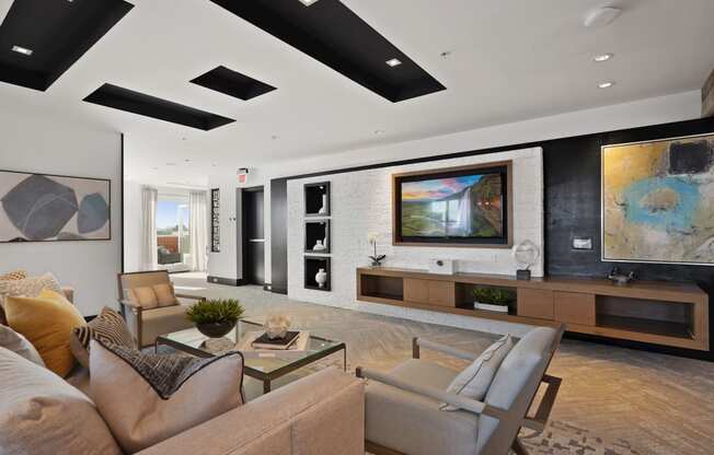 a living room with a couch and chairs and a television