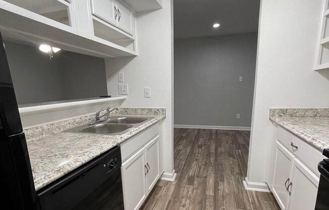 a kitchen with a stove a sink and a window