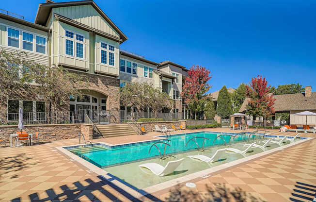 A large house with a pool in front.