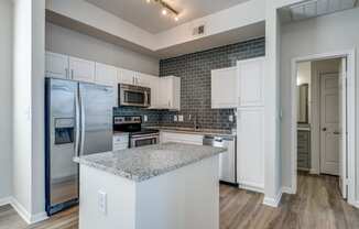 a kitchen with stainless steel appliances and a granite counter top