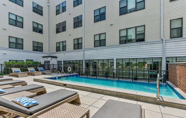 Pool with lounge chairs and a building in the background at The View at Old City, Philadelphia