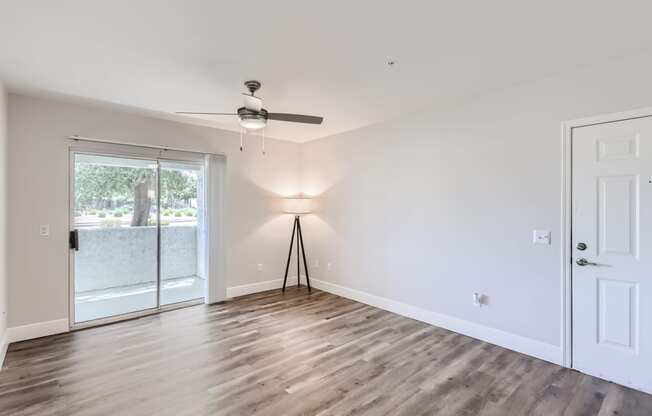 a bedroom with hardwood floors and a ceiling fan