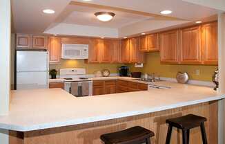 Community kitchen with appliances and C-shaped table