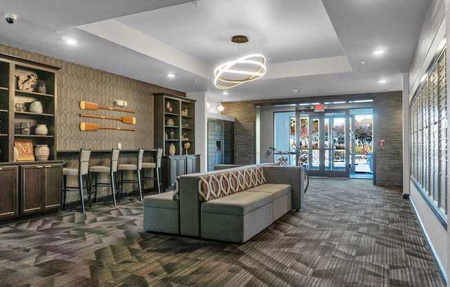 A room with a grey sofa and a brown cabinet.