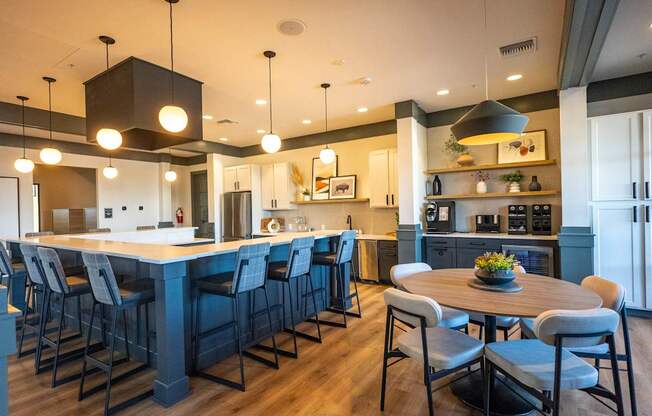 A modern kitchen with a large island and bar stools.