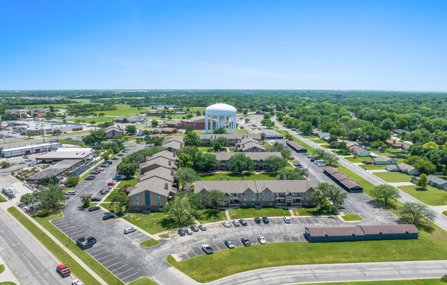 an aerial view of a city with buildings and a water tower