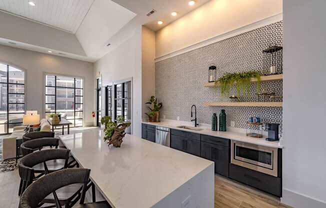 A modern kitchen with a large island and a dining area with chairs. at The One at Spartanburg, South Carolina, 29303
