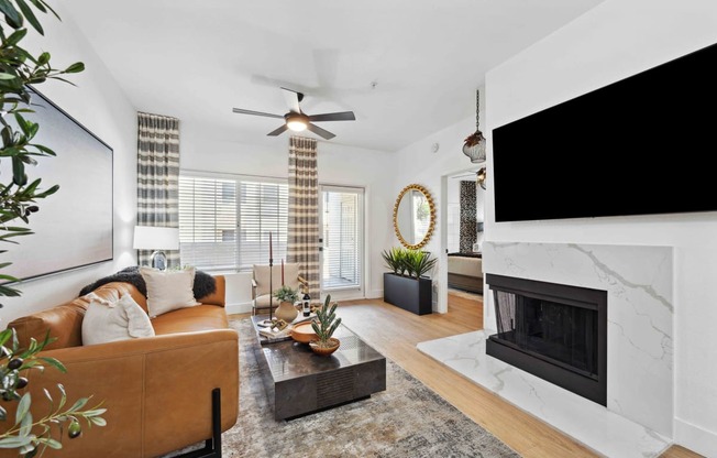 a living room with a fireplace and a large tv above it