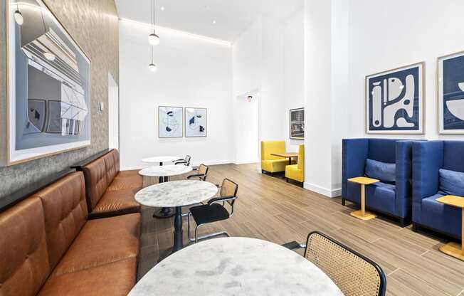 a living room with white walls and blue and yellow furniture