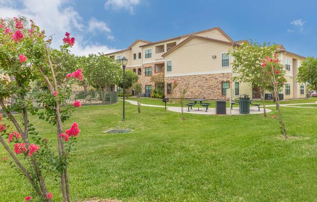 a close up of a flower garden in front of a house