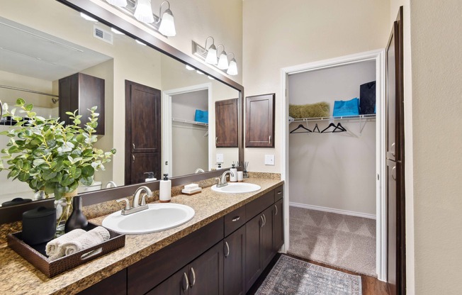 Designer bathrooms with double vanities and large mirrors.