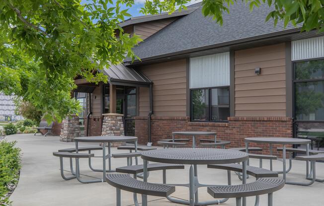 an empty park bench next to a building