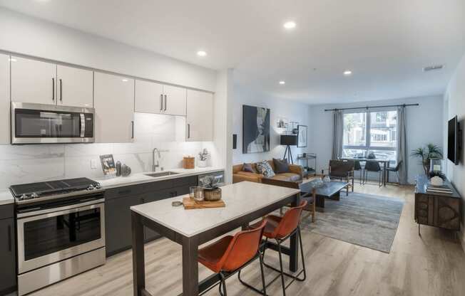 a living room with a kitchen and a dining table