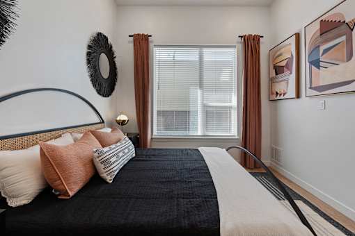 a bedroom with a large bed and a large window at SevenO2 Main Apartments, Utah