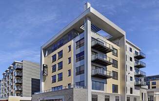 A modern building with a glass facade and balconies.