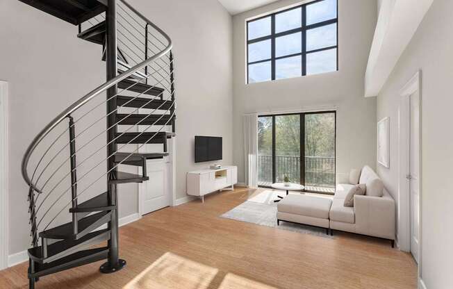 A living room with a spiral staircase and a couch.