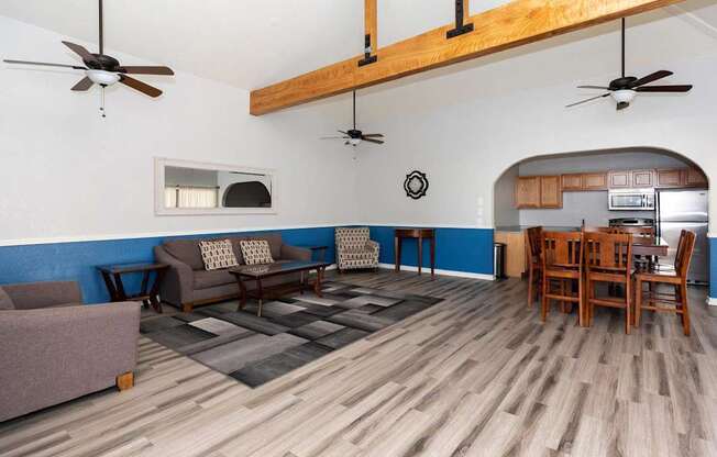A living room with a couch, chairs, and a dining table.