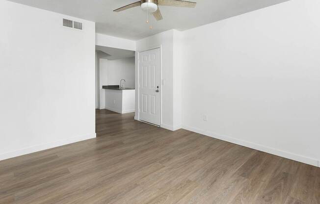 A room with a ceiling fan and light fixture.