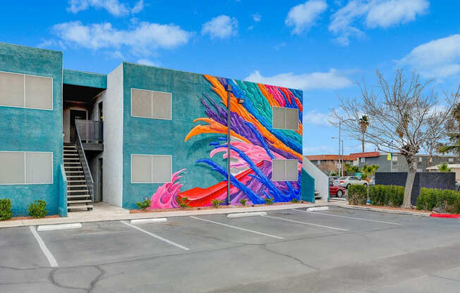 A colorful mural of a flamingo is painted on the side of a building.