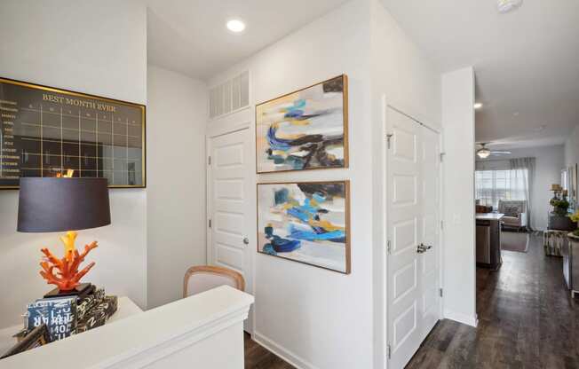 A living room with white walls and two paintings on the wall  at The Meadows, Bloomingdale, Georgia