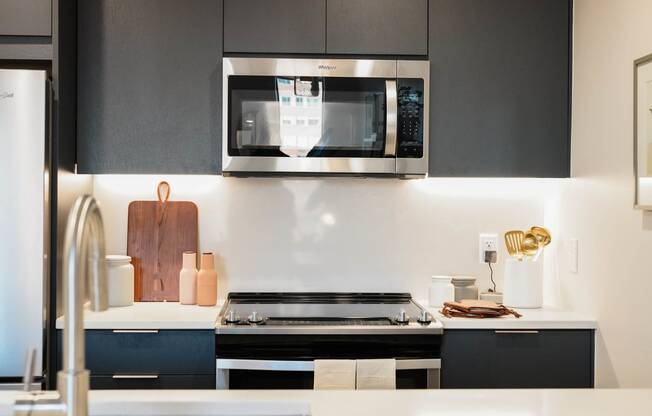 a kitchen with a stove and a microwave at The Lively, Jersey City, 07302