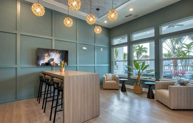 A modern living room with a bar area and a flat screen TV.