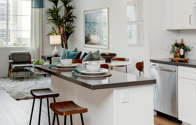 a living room filled with furniture and a window in a kitchen