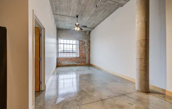 A room with a concrete floor and a ceiling fan.