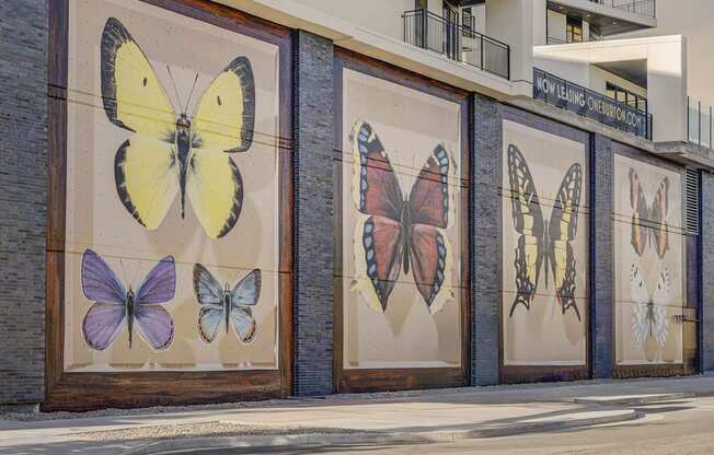 A building with a mural of butterflies on its side.
