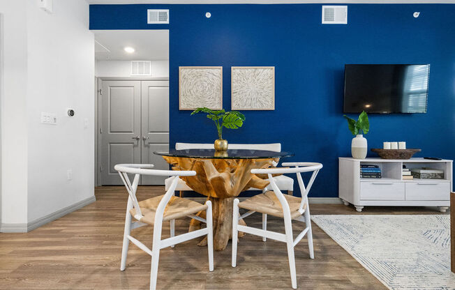 a dining room with a table and chairs and a tv