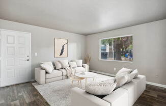 a living room with white couches and a coffee table