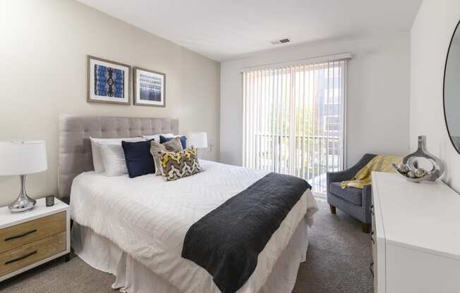 a bedroom with a bed and a couch and a window