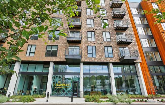 A modern building with a glass entrance and a sign that reads "CHARLEW".