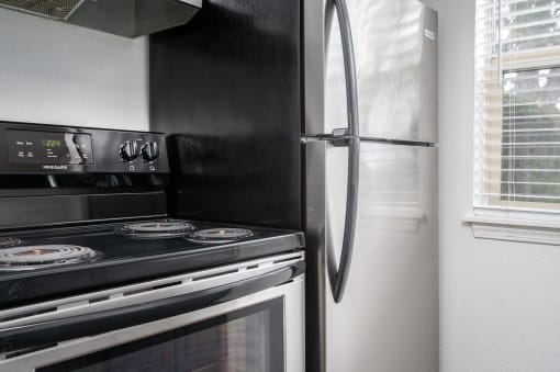 a kitchen with a stove and a refrigerator