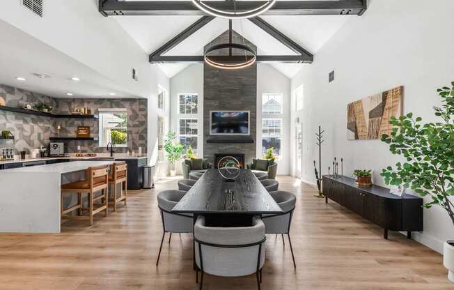 A modern dining room with a large table and chairs.