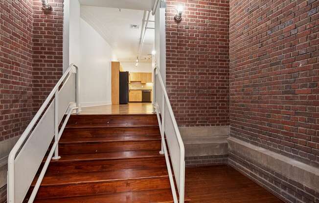 A long flight of stairs with a white railing.