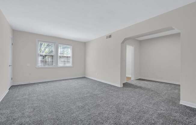 A room with grey carpet and white walls at Highland Ridge Apartments, Capitol Heights