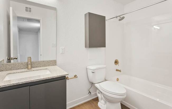A white toilet sits next to a sink in a bathroom.