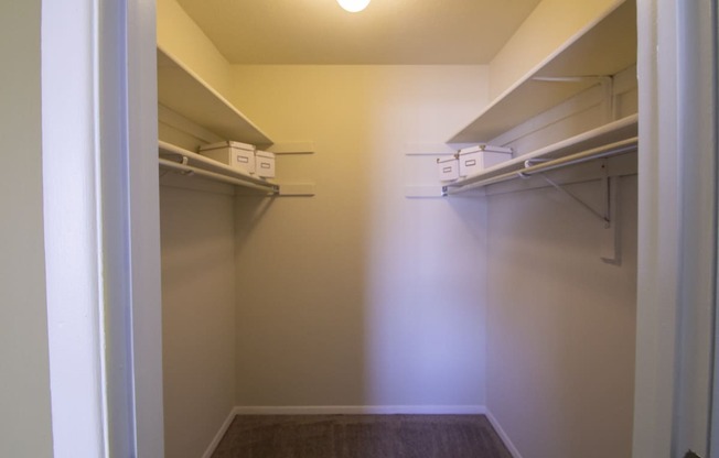 This is a photo of the primary bedroom walk-in closet in the 950 square foor, 2 bedroom apartment at Deer Hill Apartments in Cincinnati, OH.