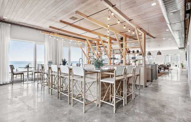 A modern kitchen with a large island and wooden beams on the ceiling.