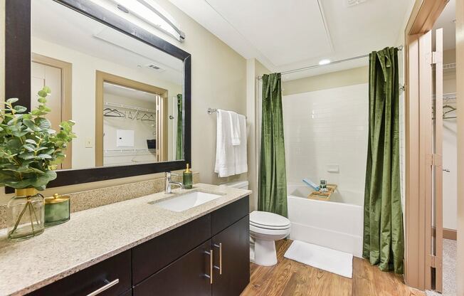 a bathroom with a sink and a toilet and a shower at Lakeline East Apartments, Cedar Park