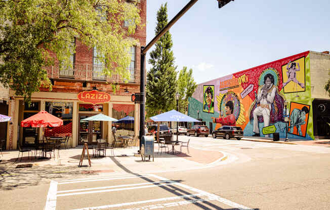 a street corner with a mural on the side of a building