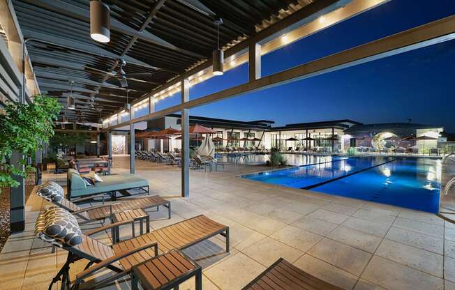 A pool area with a table and chairs.