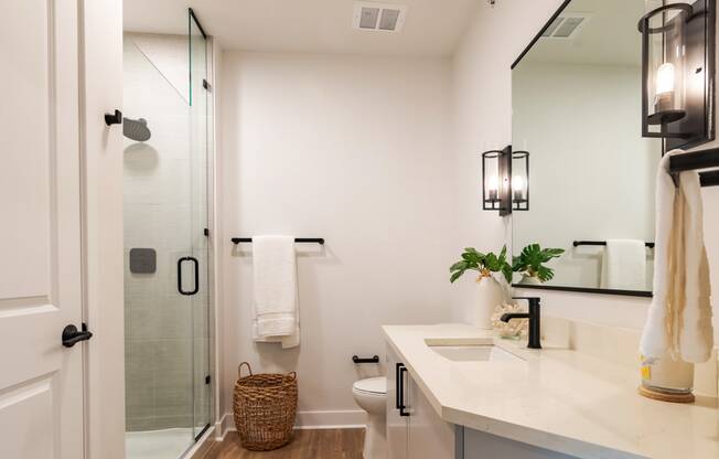 a bathroom with white walls and a large mirror  at Century West Pryor, Lee's Summit, 64081