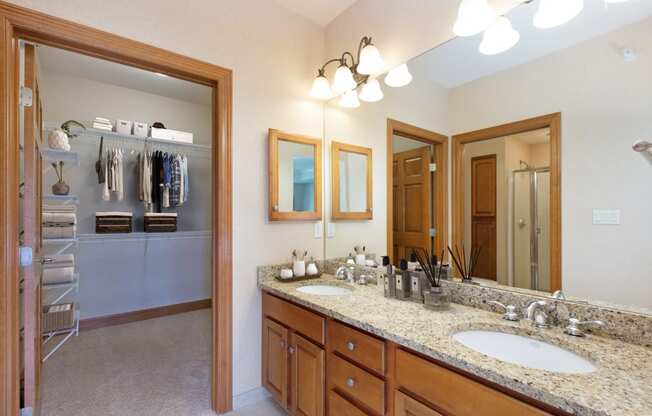 Laurel East End Apartments in Golden Valley, MN photo of a master bathroom with a double vanity and a large mirror