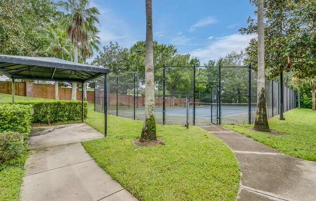 A park with a fence and a building.