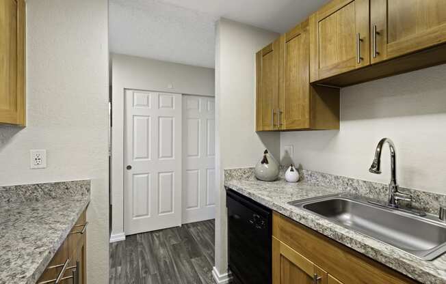 a kitchen with a sink and a dishwasher at Pacific Park Apartment Homes, Washington